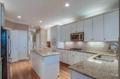 Fresh and bright, this white kitchen is on trend. New granite. Tile backsplash. Double ovens. Refrigerator stays. 