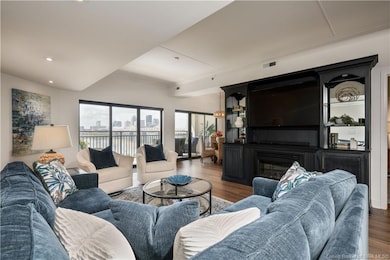 Large living room with built-ins, fireplace, TV remains.