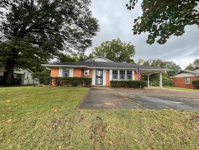 Single story home with a carport and a front lawn