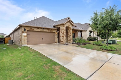 French country home featuring central AC, a garag