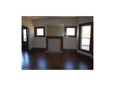 Down unit front living room with hardwood floor and newer front windows.