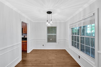 Unfurnished dining area featuring wood finished fl