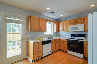 Open kitchen with hardwoods, gas stove, garden window. Refrigerator stays!