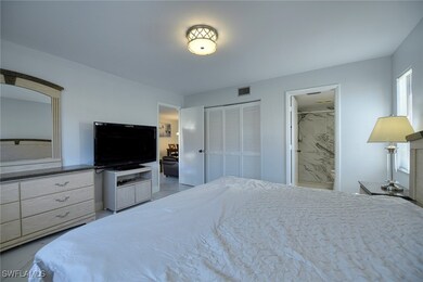 Bedroom with marble look tile flooring, a closet,