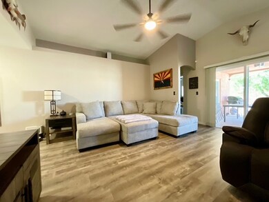 Living area featuring ceiling fan, light wood-styl