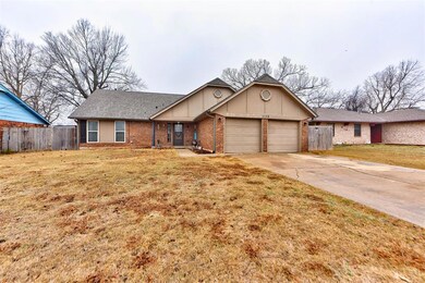 Ranch-style home with a garage and a front lawn