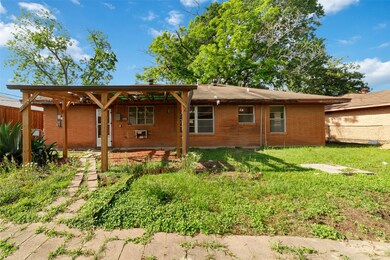 This backyard features a brick exterior, a wooden