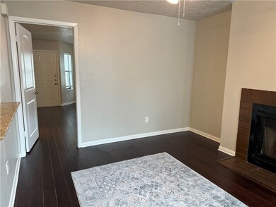 Unfurnished living room featuring a brick fireplac