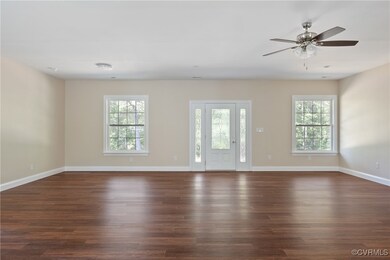Unfurnished room with ceiling fan and dark hardwood / wood-style floors
