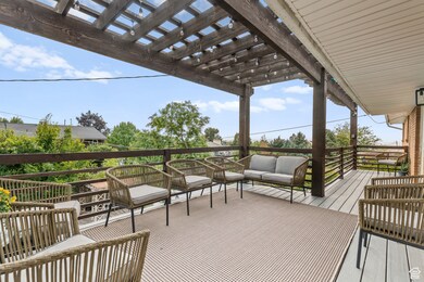 Wooden terrace featuring outdoor lounge area and a pergola