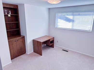 Unfurnished office with light carpet and baseboards