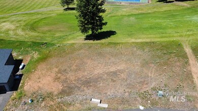 Aerial view of property's location featuring a golf course