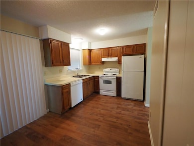 Kitchen featuring white appliances, under cabinet