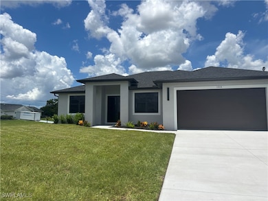 Prairie-style house featuring a front yard, drivew