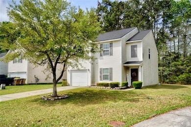 Traditional-style home with driveway and a front lawn