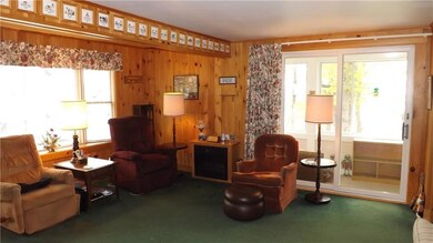 Living room with slider to enclosed...