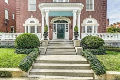 The symmetry, classical columns & Palladian windows are hallmarks of the Colonial Revival style.