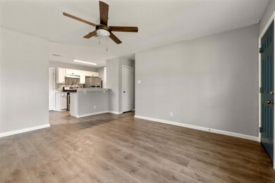 Unfurnished living room featuring a ceiling fan a