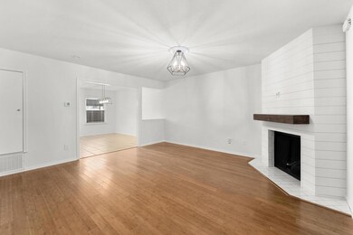 Unfurnished living room featuring a chandelier, b