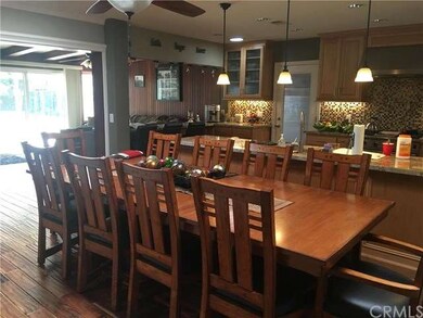 Wide angle view of dining room, kitchen leading in