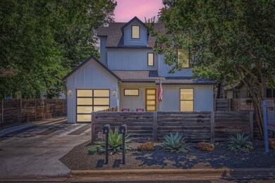 View of front of home with concrete driveway, roo