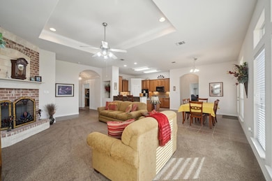Living area with arched walkways, light colored ca