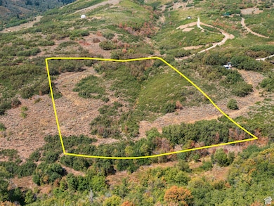 Aerial view of sparsely populated area featuring property parcel outlined