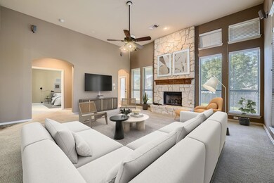 Living room featuring light carpet, ceiling fan, p