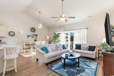 Living room featuring ceiling fan, hardwood / wood