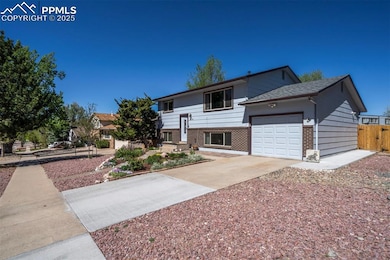 View of front of home featuring brick siding, driv