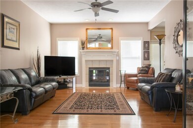 GREAT ROOM FEATURES HARDWOOD FLOORS, GAS FIREPLACE WITH CANNED ACCENT LIGHTING AND CEILING FAN