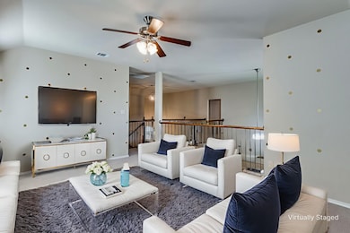 Living room featuring a ceiling fan and carpet