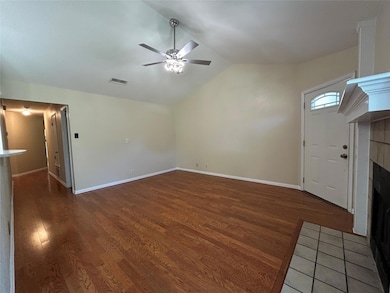 Unfurnished living room featuring a tiled firepla