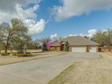 Single story home featuring a garage and a front y