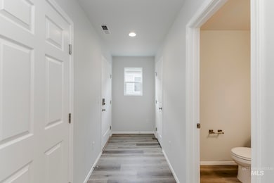 Hallway featuring light wood-style floors and recessed lighting