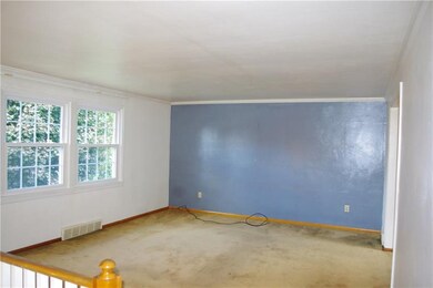 Living room is light and bright with neutral dcor'