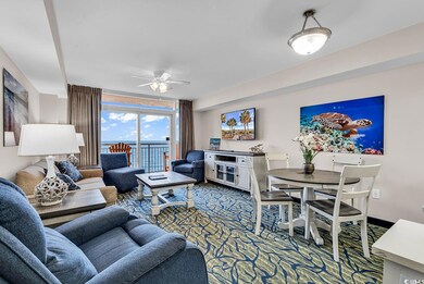 Carpeted living area featuring a ceiling fan