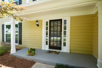 View of exterior entry featuring covered porch