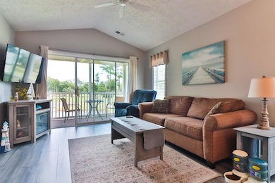 Living room with vaulted ceiling, a textured ceili