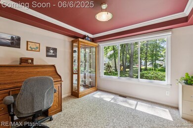 Peaceful views and a cozy workspace in the dining room with a pop of personality in the ceiling.