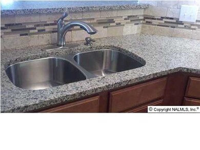 Classic double stainless steel sink for the serious chef. Plus, backsplash shines with decorator detail with accent of glass & tumbled stone banding.