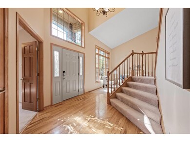 Large, open foyer with hickory flooring