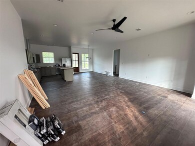 Living area featuring ceiling fan and dark wood-s