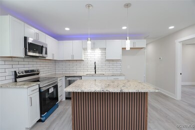 Kitchen with white cabinets, stainless steel appli
