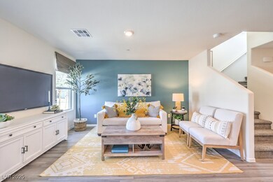 Living area with baseboards, visible vents, wood f