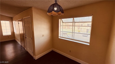 Spare room featuring dark wood-type flooring, base