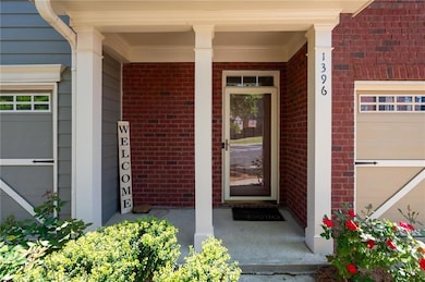 Doorway featuring brick siding and covered porch