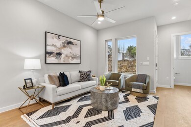 Living area with ceiling fan, light wood finished