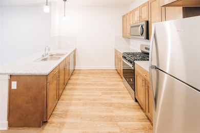 Kitchen featuring appliances with stainless steel