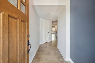 This welcoming entryway features a solid wooden do